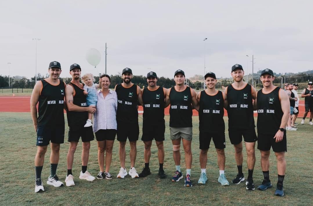 The Miles for Merrick runners in Never Alone singlets at the Narellan athletics track, October 2024